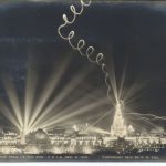 Photograph of a postcard depicting a night scene of a city