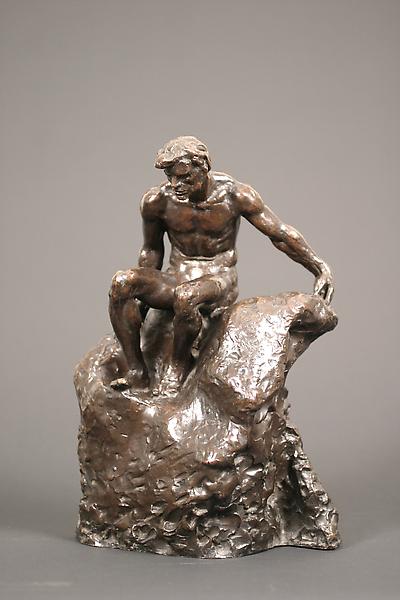 Image of a sculpture of a man sitting on a rock