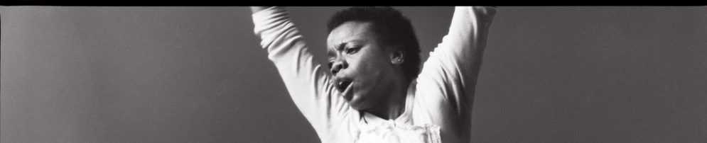 header image showing a black woman jumping with her arms in the air