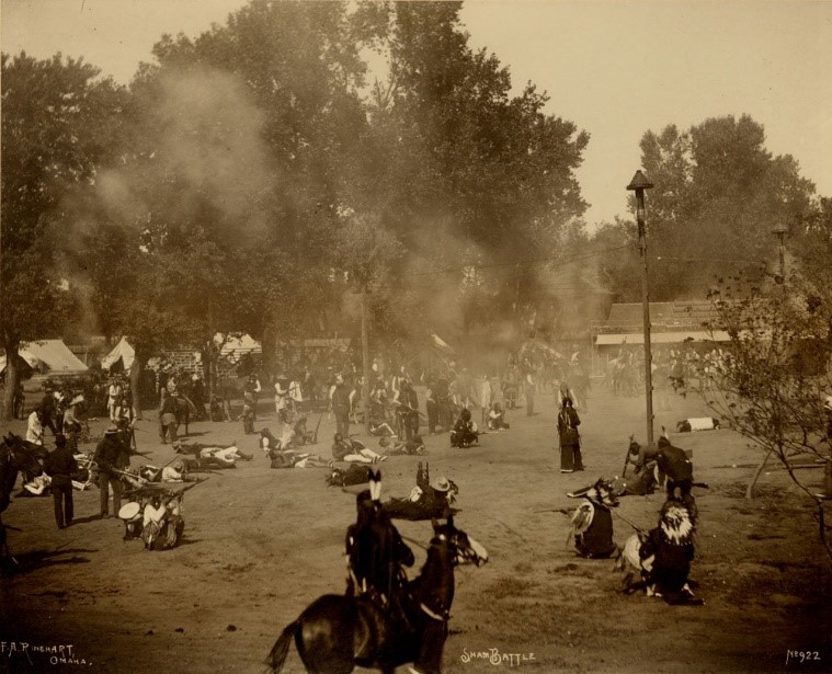 image of an open area with several people, horses, and tents