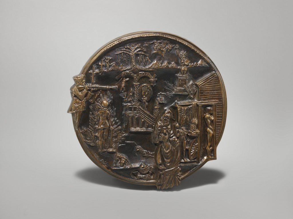 Circular bronze medal featuring images of war