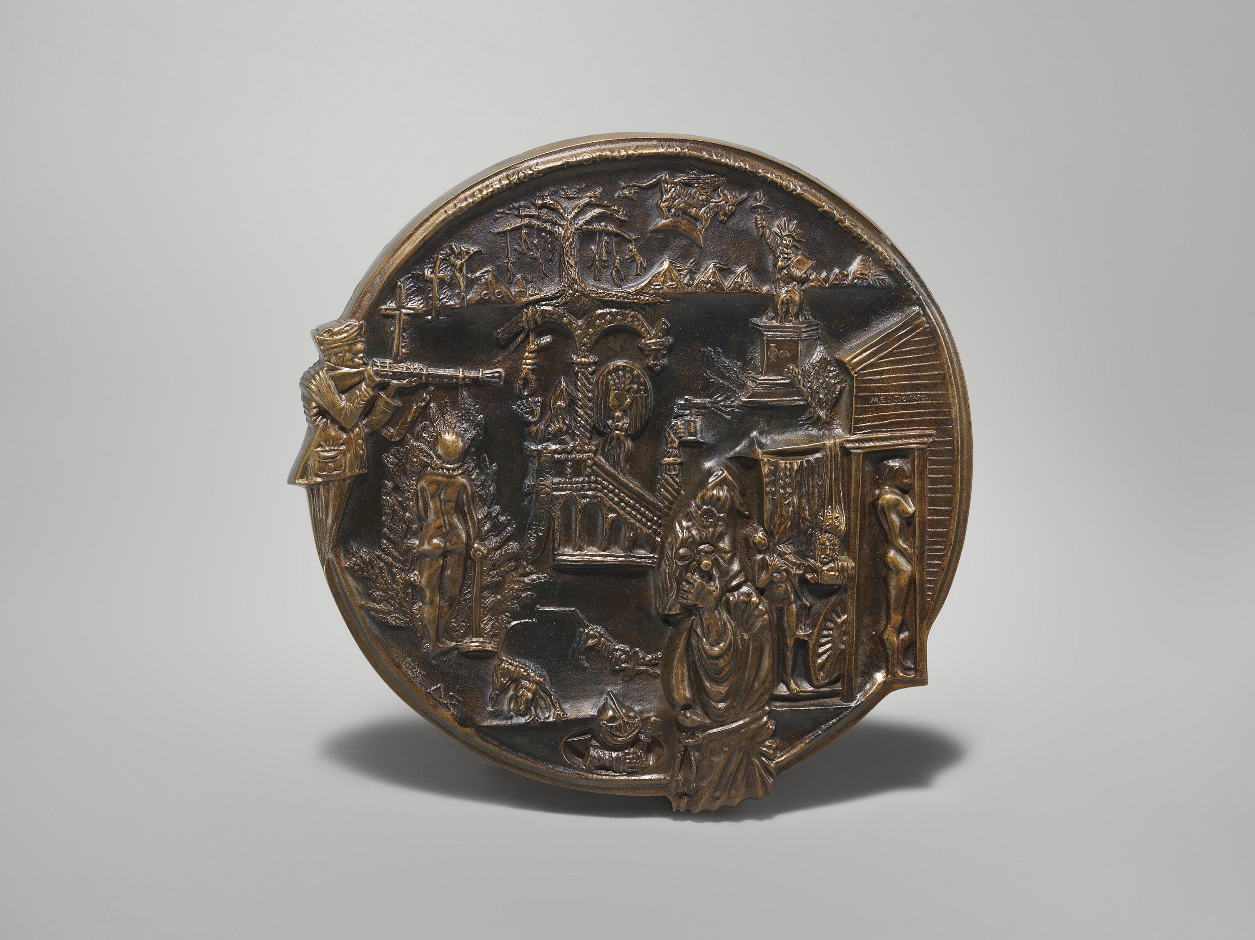 circular bronze medal featuring images of war