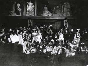 Black-and-white photograph of a costume party with several people in blackface