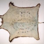 Outstretched animal hide with drawn decorations on the interior, arranged in concentric circles