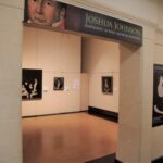 Museum gallery entrance to an exhibition with sign reading JOSHUA JONHSON PORTRAITIST OF EARLY AMERICAN BALTIMORE