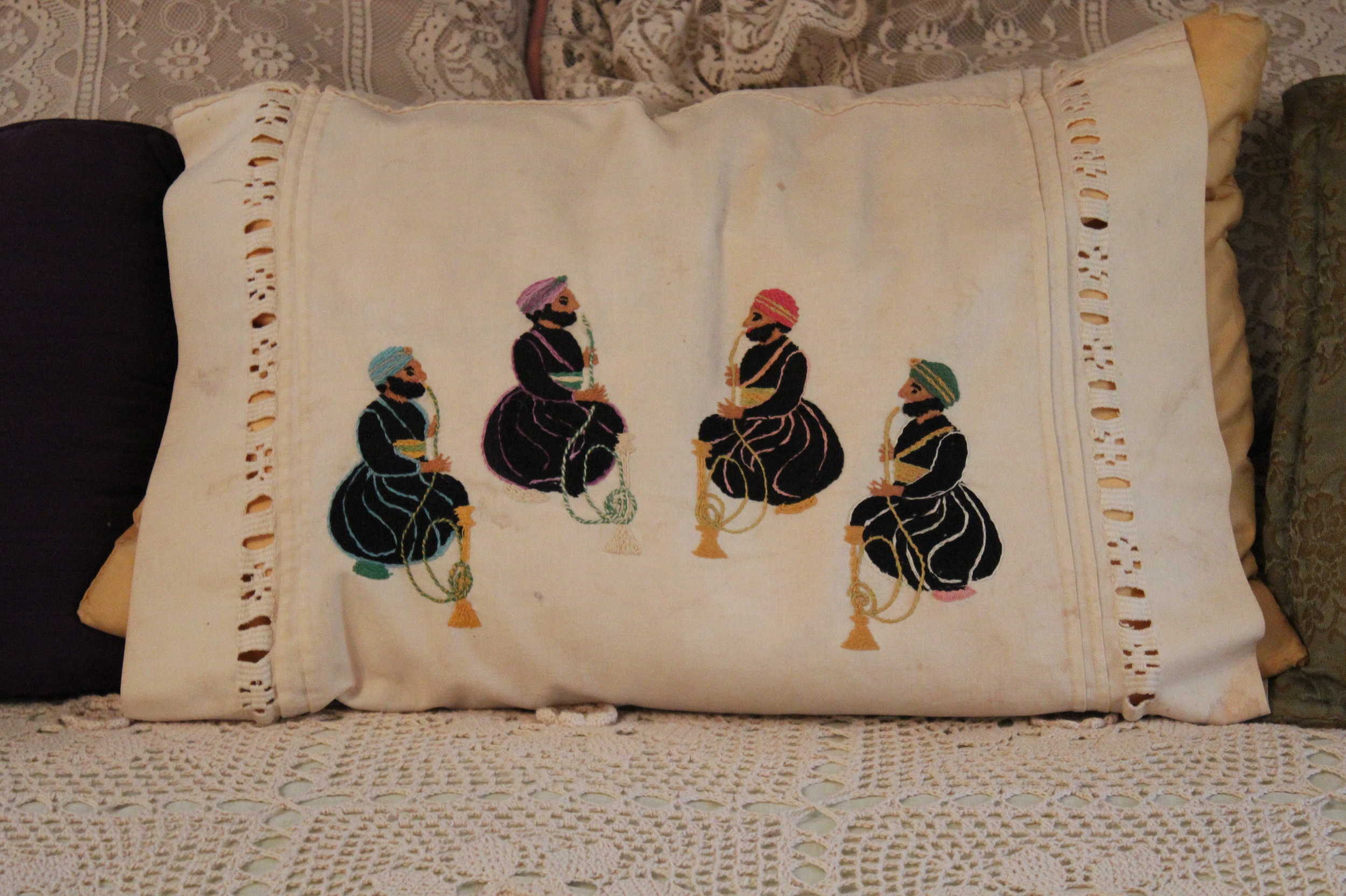 Pillowcase embroidered with four men in black robes and different-colored turbans smoking hookah pipes