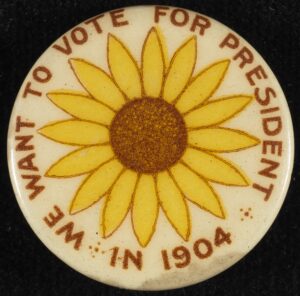 Round button-style pin reading "We Want to Vote for President in 1904" around the perimeter, with a sunflower in the center