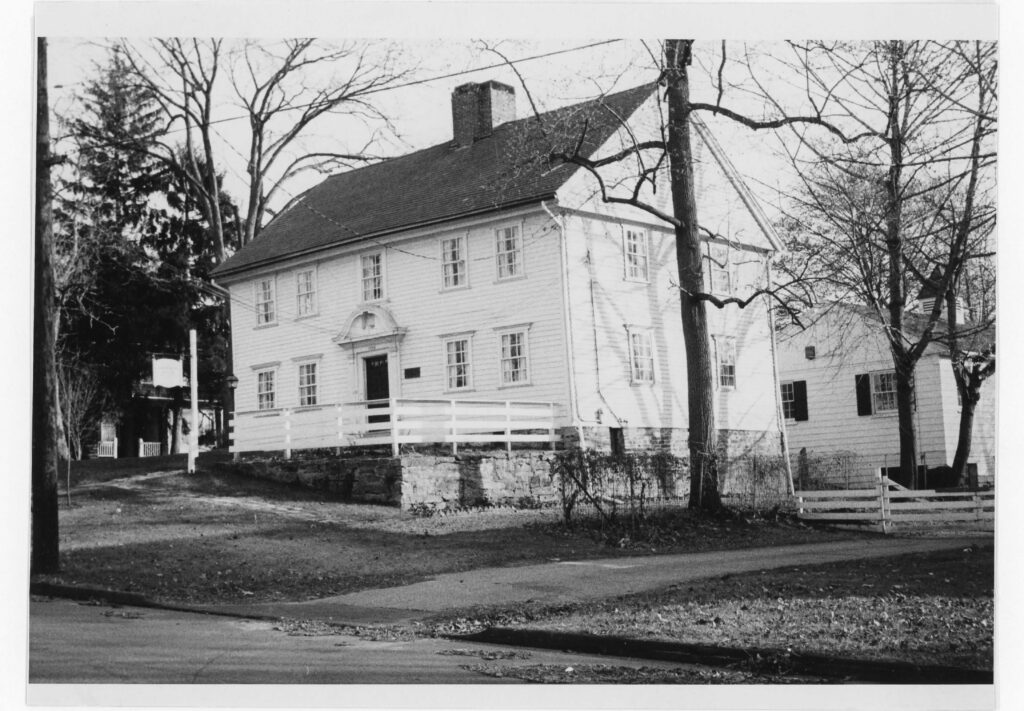 Black and white photograph of a colonial American house