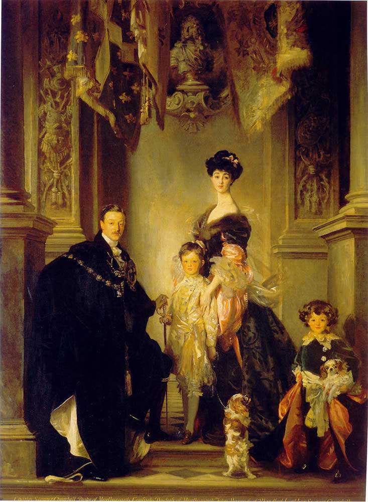 Oil painting of a family posed in an ornate interior: a man in a dark cape, a woman with dark upswept hair and a long neck, two children, and two small brown and white dogs.