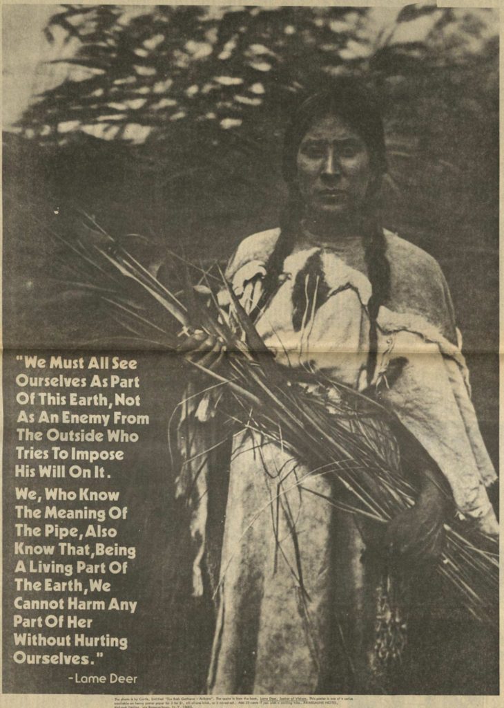 Black-and-white duotone photograph of a young Native American holding stalks of vegetation diagonally across her body. The caption reads "We Must All See Ourselves As Part Of This Earth, Not As An Enemy From The Outside Who Tries To Impose His Will On It. / We, Who Know The Meaning Of The Pipe, Also Know That, Being A Living Part Of The Earth, We Cannot Harm Any Part Of Her Without Hurting Ourselves. / —Lame Deer