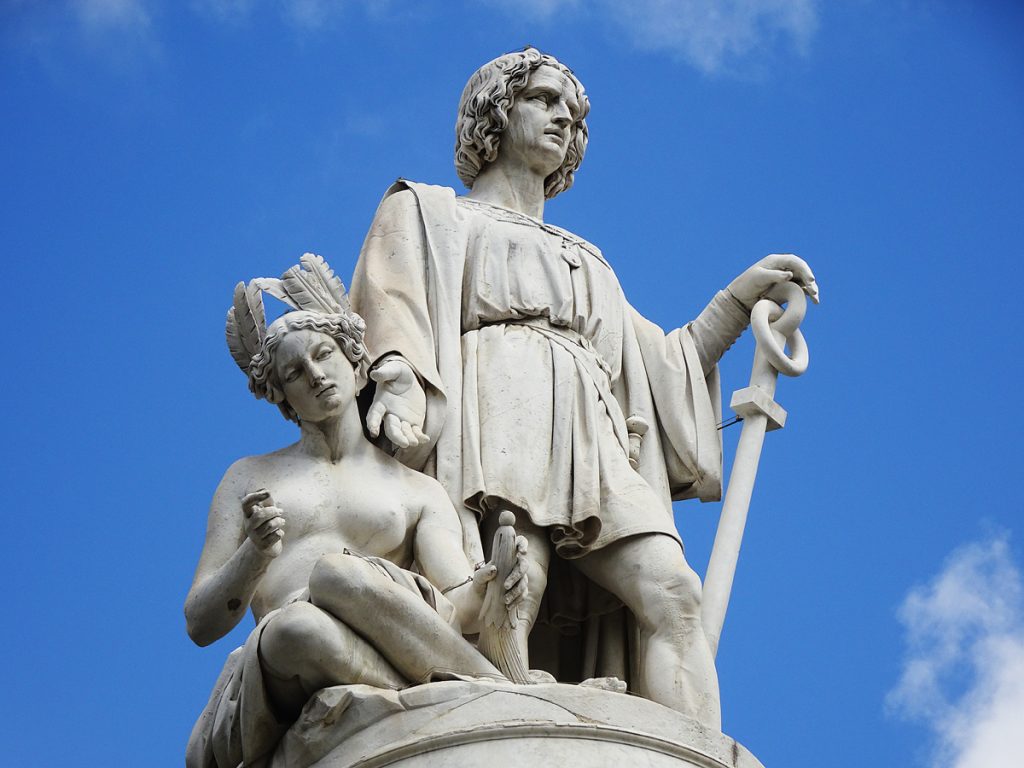Detail of the main sculptural element in fig. 11, showing the figure of Columbus grazing the cheek of an Indigenous woman, kneeling at his feet, with his right hand.