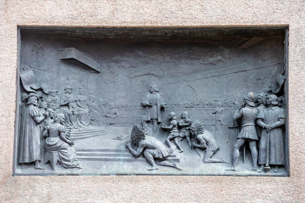 Bronze relief sculpture showing Columbus presenting Indigenous Americans at the court of Ferdinand and Isabella of Spain.
