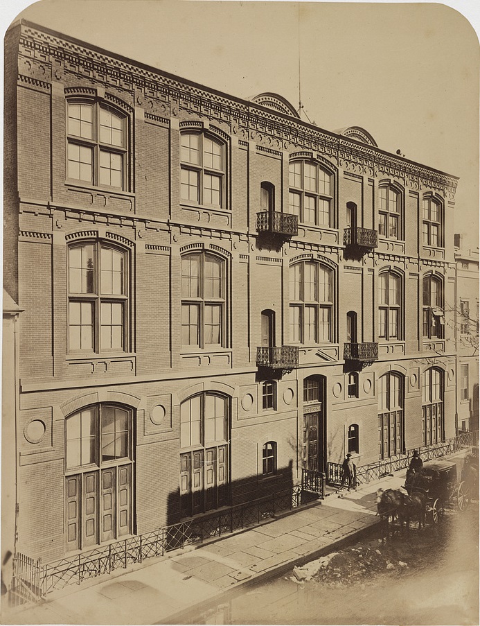 Black-and-white historic photograph of building with large, arched windows