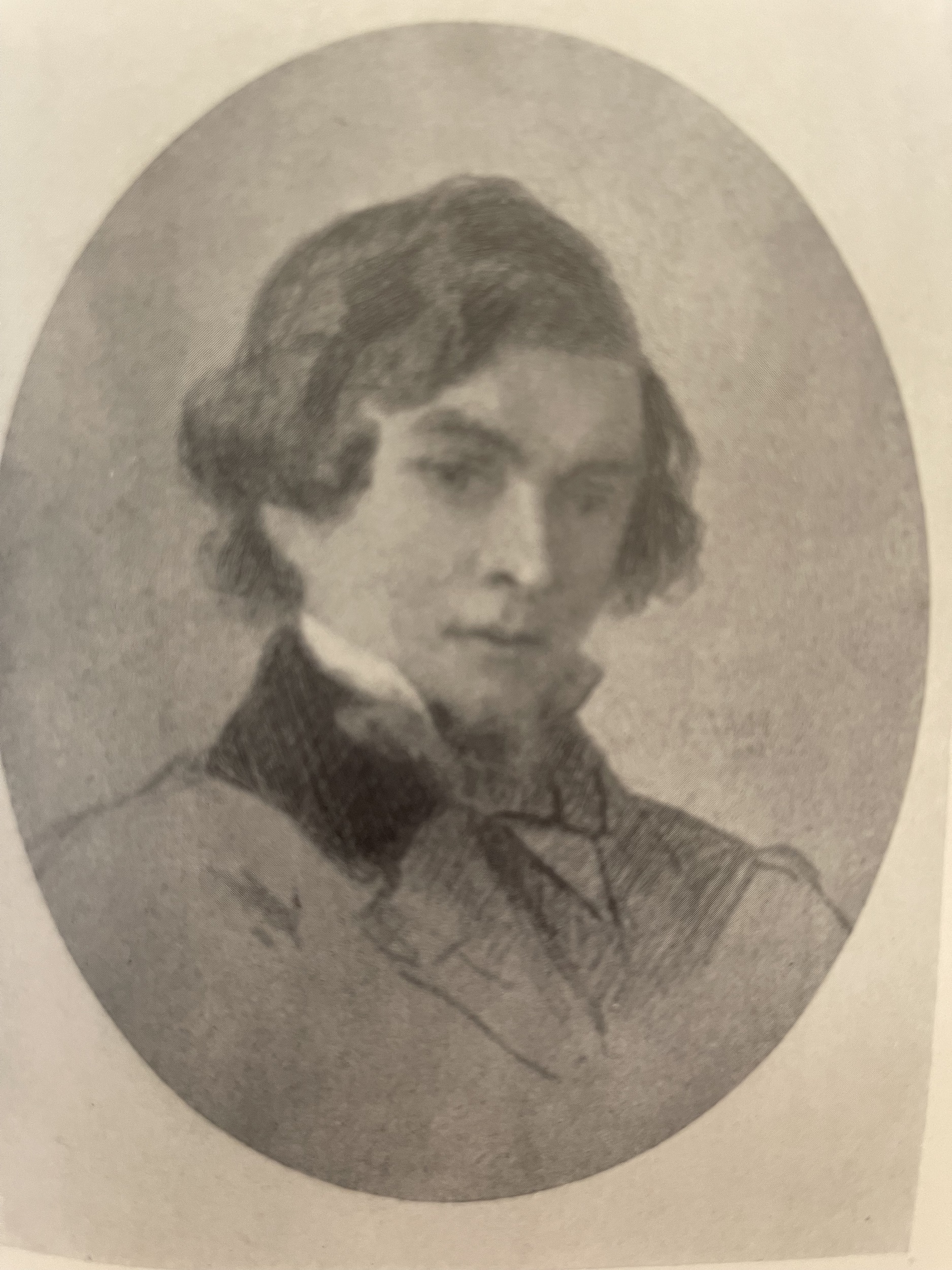 Black and white reproduction of a crayon portrait of a young man in a suit and cravat.