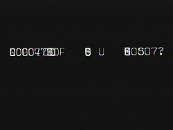 Black-and-white screenshot with largely unintelligible letters and numbers that look like computer code; it is similar to the display on the computer screen in fig. 5