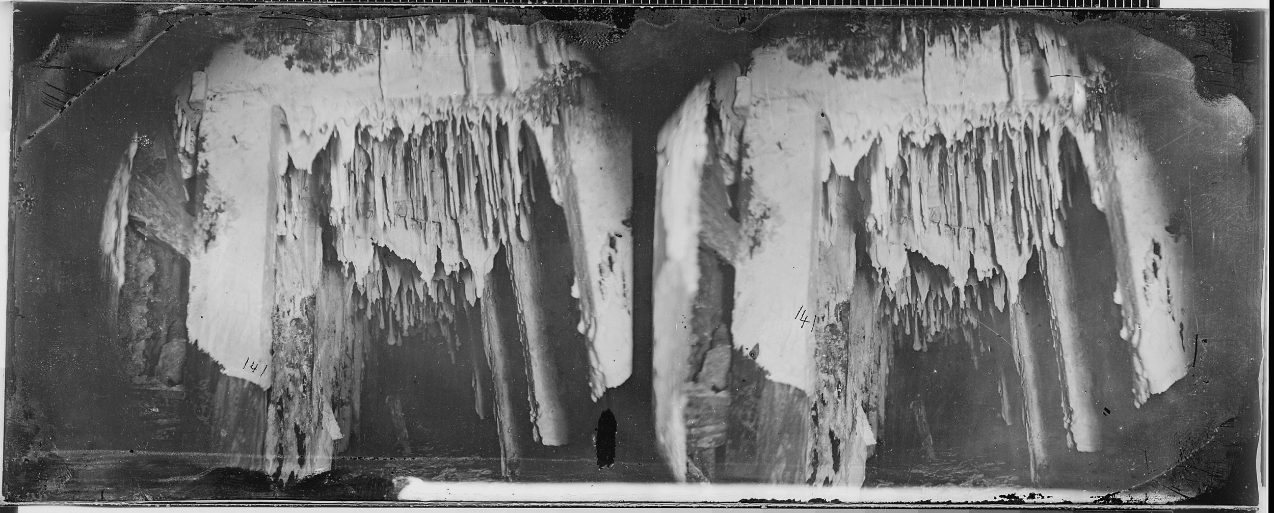 Black-and-white stereoview of the interior of a mine, showing jagged, vertical growths.