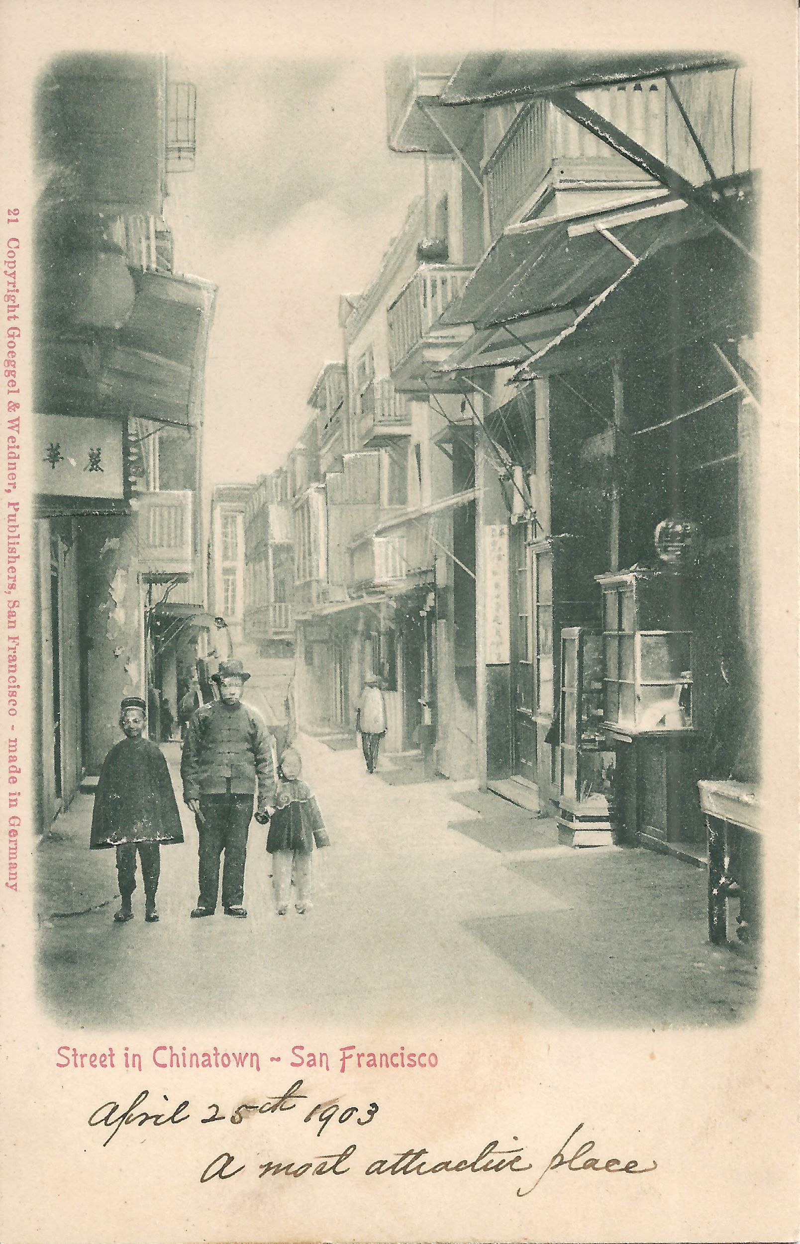 Black-and-white photo postcard of three figures walking down a narrow city street. Underneath, in red, are the words "Street in Chinatown - San Francisco," and then underneath that, in script, "April 25th 1903 / A most attractive place." Along the left side is a copyright notice, also in red.