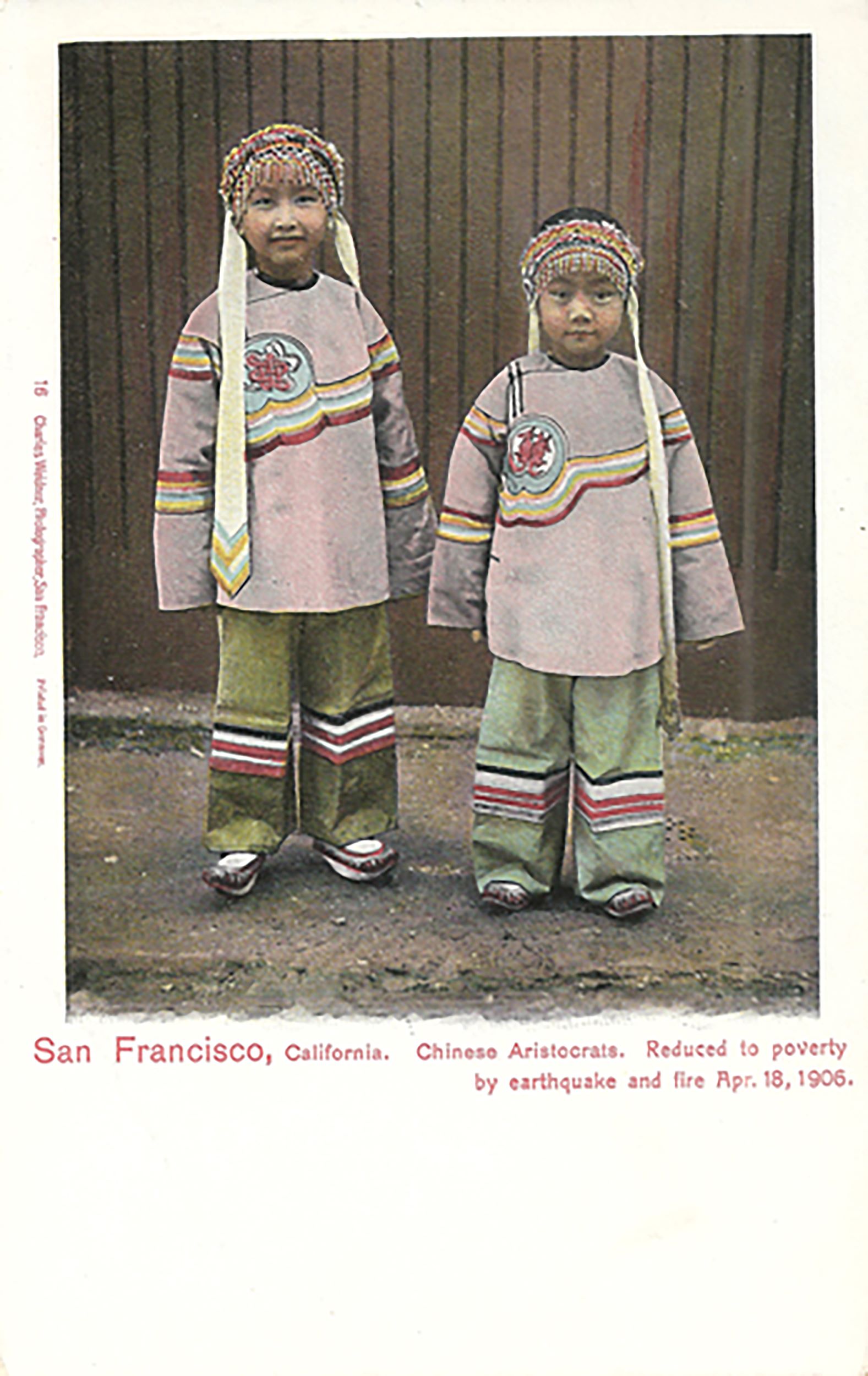 Hand-colored postcard showing two young children in traditonal Chinese dress. The caption underneath, in red, reads "San Francisco, California / Chinese Aristocrats. Reduced to poverty by earthquake and fire Apr. 18, 1906"