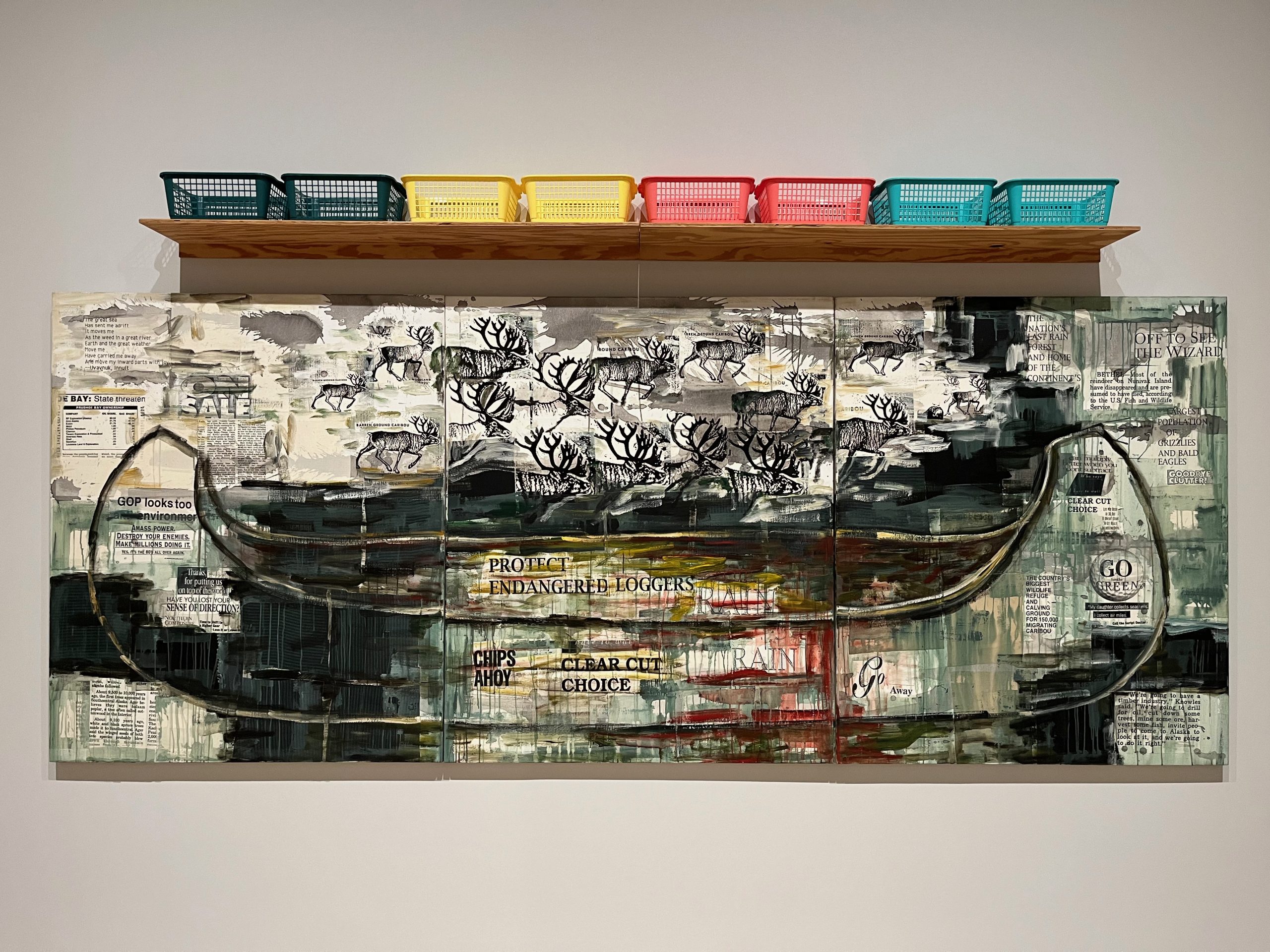 Abstracted, horizontal painting of a canoe with collaged words and figures of elk or deer. Above the painting is a wooden shelf with eight plastic bins of different colors.