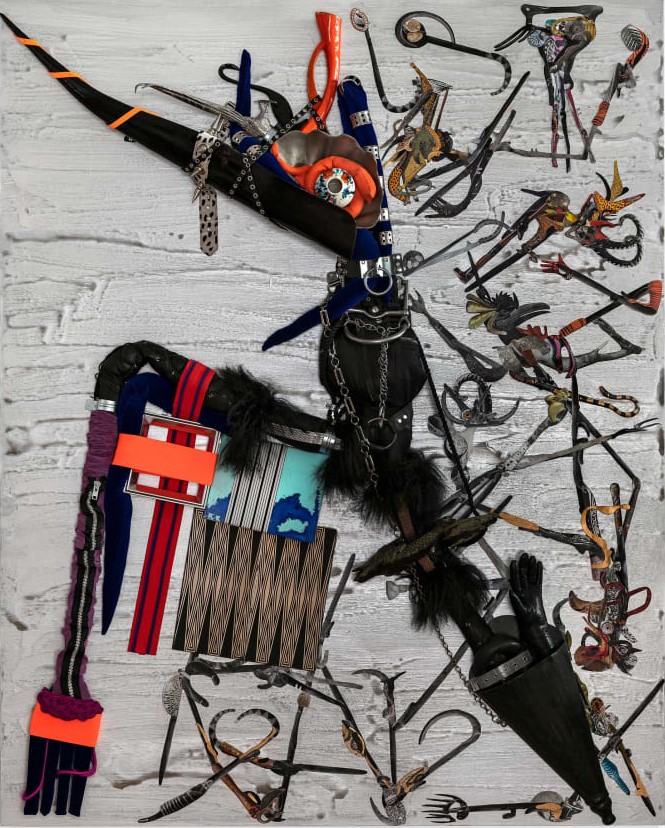 Abstract, collaged work of art including strips of leather, feathers, zippers, and metal hooks on a white background.