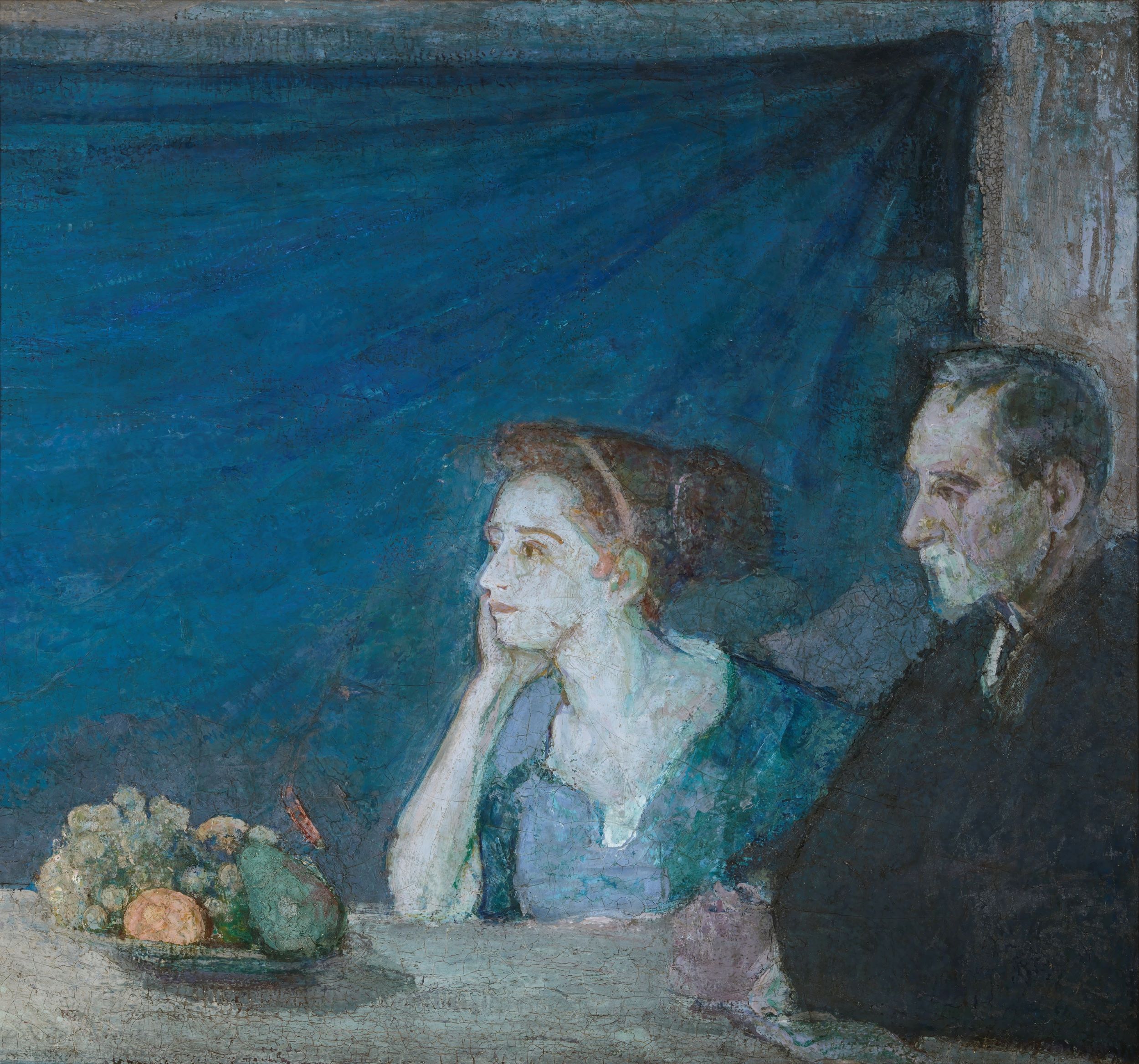 Oil painting of a man and a woman, both seated in front of a table covered with a white cloth, on top of which rests a bowl of fruit. The woman and man are both on the right side of the canvas, looking to the left. The background is a deep blue, apparently a cloth secured in the upper right corner.