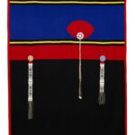 Abstract design in stripes of bright blue, red, yellow and deep black. Hanging over the stripes are three intricately beaded strips with tassels; the center one has a large red plume placed over the wide blue stripe.