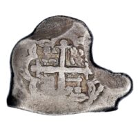 Fragment of a silver coin, now an uneven shape, with a prominent cross in the middle.