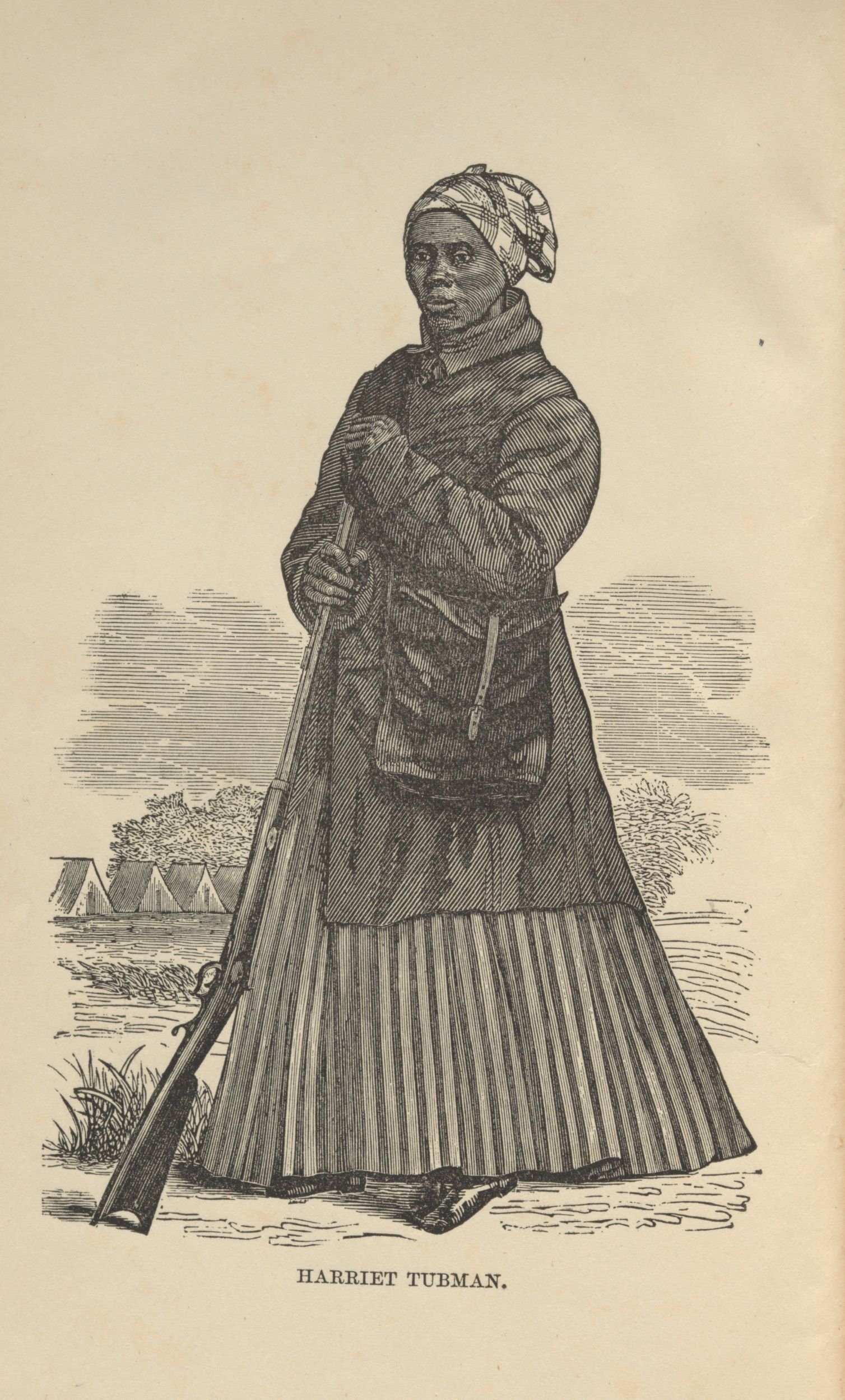 Black-and-white wood engraving showing a black woman holding a rifle, standing in a landscape with military tents on the horizon. She wears a headscarf, a long dress, and a long coat, and underneath he is the inscription "Harriet Tubman."